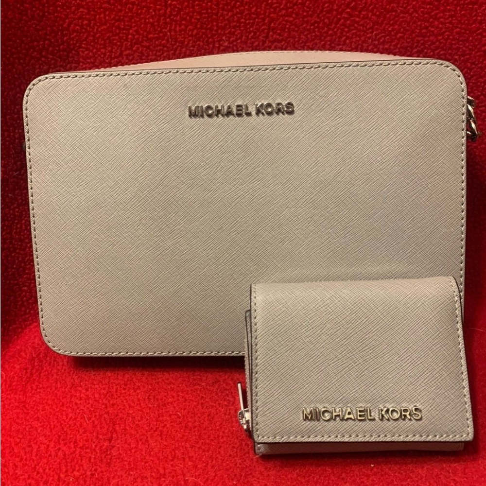 Grey Michael Kors Crossbody with matching tri-fold wallet.